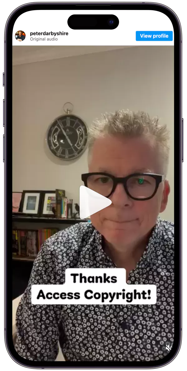 Man with glasses in patterned shirt in a home office, bookshelves and clock behind. Text overlay reads, “Thanks Access Copyright!” Calm expression.